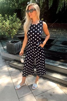 With a flattering, classic navy and white print, a cinched waist and a sleek sleeveless finish, this polka dot cullotte jumpsuit by Mela is that multi-use garment your wardrobe's been missing. Whether it's a trainers of heels type of day, this jumpsuit has you covered. Product Code: 4C9O0FC3 Cinched Waist, Navy And White, Wardrobe Essentials