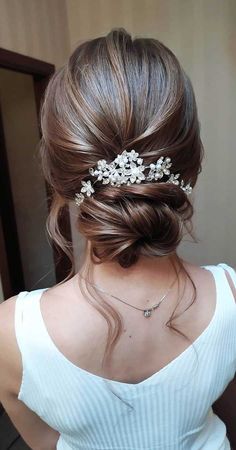 a woman wearing a hair comb with flowers in it