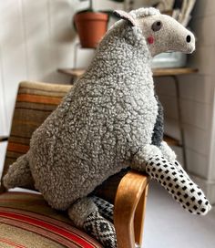 a stuffed animal sitting on top of a wooden chair