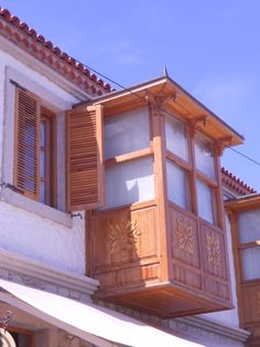 a building with wooden balconies and shutters