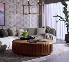 a living room filled with furniture and a chandelier hanging over the top of it