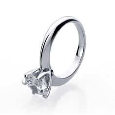 Created a unique six-prong setting. From its unadorned band with a tapered sleeve to the stone setting, the design was all about maximizing the beauty of the center stone. Our 925 Sterling Silver Ring Round 1.5 carat CZ Stone 6 prong Classic Solitaire Wedding Engagement Ring is a classic ring. The high setting gives the stone the look of a delicate flower and the tapered band makes your finger look slender while drawing the eye towards the shining solitaire stone. The ultimate classic, this ring Modern Moissanite Diamond Promise Ring, Timeless Solitaire Promise Ring, Modern Solitaire Promise Ring, Diamond White Tension Setting Wedding Ring For Promise, Promise Ring With Tension Setting In Round Band, Cubic Zirconia Promise Ring With Tension Setting, Timeless Moissanite Wedding Rings With Tension Setting, Modern Moissanite Promise Ring, Modern Lab Grown Diamond Promise Ring