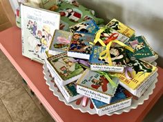 there are many children's books on the table and one has a yellow ribbon