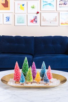 a tray with christmas trees on it in front of a blue couch