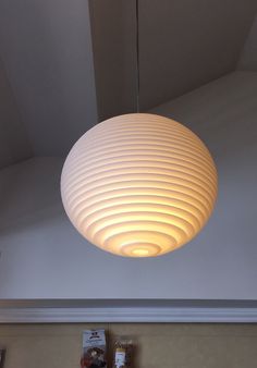 a white lamp hanging from the ceiling in a room