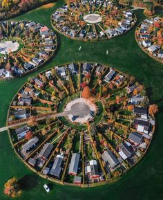 an aerial view of a circular park with lots of houses in the middle and trees around it