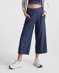 These look like classic work pants, but move like your favorite activewear. Our cropped Performance Tech Wide Leg Commuter Pants have just the right amount of stretch for days when you’re on the go, plus the sun protection and quick-dry properties of top-notch performance wear. And they look great with sneakers.  | Quince | Women's Performance Tech Wide Leg Pants in Navy, Size Large, Recycled Polyester Paperbag Pants, Cropped Wide Leg Pants, Travel Pants, Lightweight Pants, Ponte Pants, Performance Leggings, Cotton Chinos, Wide Leg Linen Pants, Performance Wear