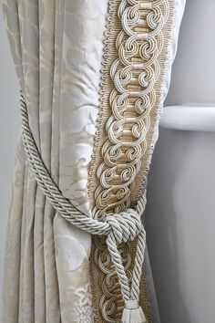 a curtain with rope and tassels attached to it