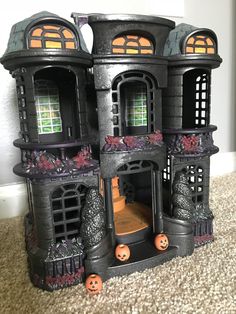 a halloween house with pumpkins on the ground