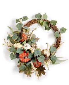 a wreath with pumpkins and leaves on it