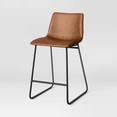 a brown chair with metal legs and a seat cushion on the back, in front of a white background