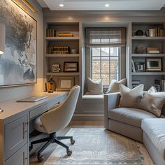 a home office with built - in bookshelves, desk and couches is shown