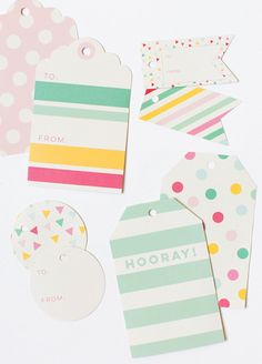 several tags and tags on a white surface with polka dot dots, stripes, and triangles