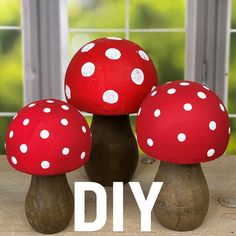 three red mushrooms with white polka dots on them sitting in front of an open window