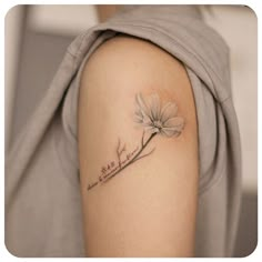 a woman with a tattoo on her arm has a dandelion flower in it