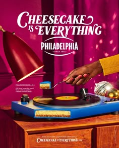 a poster for cheesecake is everything featuring a person using a turntable to record