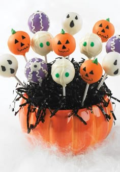 halloween cake pops in an orange pumpkin container