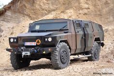 an army vehicle is parked on the side of a hill