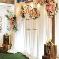 the wedding stage is decorated with flowers and greenery