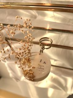 a glass vase filled with flowers on top of a metal shelf next to a mirror