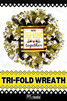 a yellow and black wreath with words on it that read we belong together, tri - fold wreath