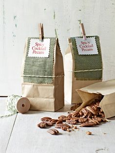 two paper bags filled with nuts on top of a table