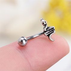 a tiny silver nose ring with an octopus on it's end and a ball in the middle