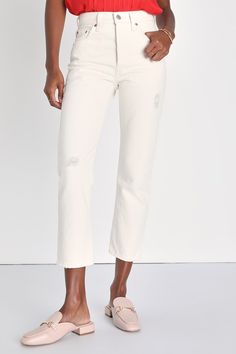 You can never go wrong with a classic like the Levi's 501 Crop Ivory Distressed High Rise Straight Leg Denim Jeans! Sturdy denim (in Levi's Ecru Booper) creates a high waist, five-pocket cut, belt loops, and a branded top button with a hidden button fly. Straight pant legs, with subtle distressed details throughout, taper slightly at the cropped, slightly distressed hems. Red logo tag and leather patch at back. Fit: This garment fits true to size. Length: Mid-calf length. Size 28 Inseam: 26.00 F Cream Cropped Leg Jeans For Spring, Distressed White Straight Leg Jeans, Beige Straight Leg Jeans With Frayed Hem, Cream Relaxed Fit Denim Jeans, Cream Denim Jeans Relaxed Fit, Casual Cream Cropped Leg Jeans, Casual Mid-rise Cream Jeans, Casual Cream Cropped Jeans, Classic Cream Jeans For Spring