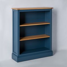 a blue bookcase with two wooden shelves