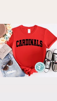 These Cardinals varsity shirts are a perfect addition to your school spirit wear and are super cozy!  ❗️Sizes: Toddler-2T-5T  Youth XS-XL  Adult S-XL  Adult 2X Adult 3X Available in short sleeve, long sleeve and sweatshirts!  Shirts are all unisex sizing!  The shirt has cardinals printed and pressed onto the shirt! Cardinals is written in distressed black vinyl!  If you would like to request a custom order, please send us a message!! Cardinals Spirit Wear, School Spirit Tops With University Logo For Fan Gear, University Logo Tops For School Spirit Fan Gear, Casual Tops With University Logo For Game Day, University Logo Tops For Sports Season, Collegiate T-shirt With Lettering For College, Varsity Tops With University Logo For College, Red T-shirt For School Spirit In Fall, Red Varsity T-shirt With Team Name