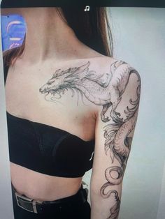 a woman with a dragon tattoo on her shoulder