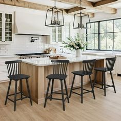 a kitchen with an island and four stools