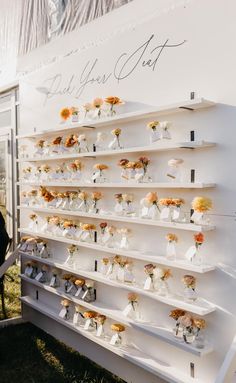 a white display case with flowers on it