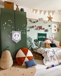 a child's bedroom with green lockers, bedding and decorations on the walls