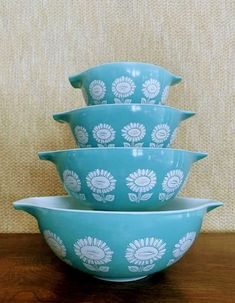 four blue bowls stacked on top of each other