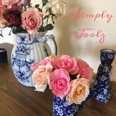 there are many flowers in the blue and white vases next to each other on the table