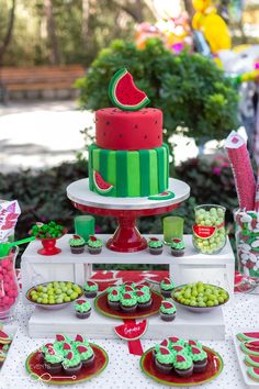 a watermelon themed birthday party with cupcakes and desserts on the table