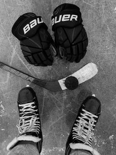 two pairs of hockey gloves sitting on top of an ice rink next to each other