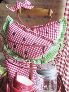 red and green gingham cloths in a metal basket with a wooden handle