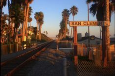 a train track with palm trees and a sign that says san clement