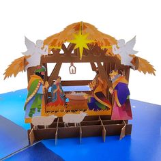 an origami nativity scene with angels and sheep