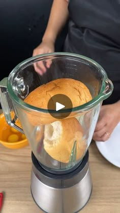 a blender filled with bread on top of a wooden table