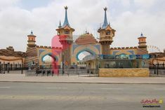 a large building with two towers on top of it's sides and an archway leading to the entrance