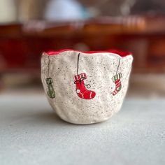 a small ceramic bowl with christmas decorations on it