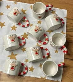 christmas themed cups and saucers on a table