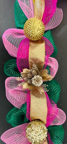 a close up of a wreath made out of mesh and flowers on a black background