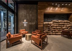 a room filled with lots of furniture next to a pile of sand bags on the wall