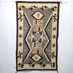 an old navajo rug hanging on the wall