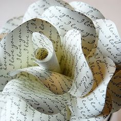 a close up of a paper flower with writing on it