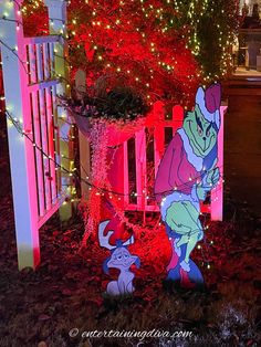 an outdoor christmas display with lights and decorations